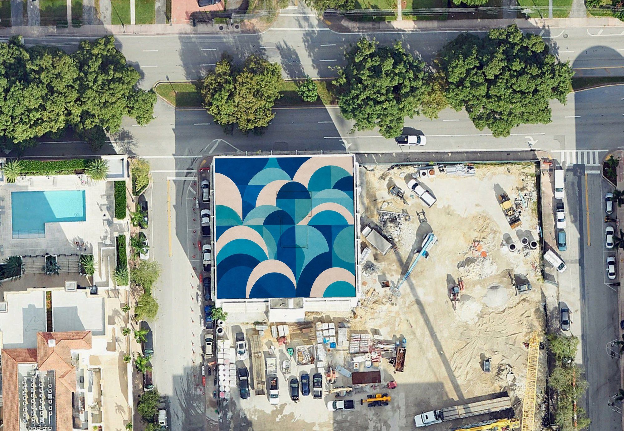 Aerial view of a residential building roof covered in overlapping arcs of navy, teal and sand, beside a construction site