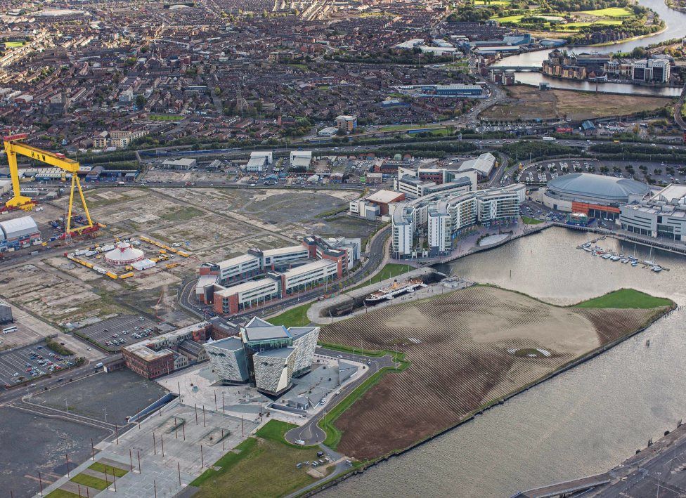 Aerial view of Belfast's Titanic Quarter with the 11-acre portrait Wish beside the water